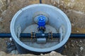 The water supply valve is located in the pit and is painted blue