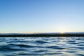 Water surface. View of a Sunset sky background. Dramatic gold sunset sky with evening sky clouds over the sea. View of a Crystal c Royalty Free Stock Photo