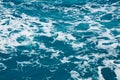 Water surface. Wake waves and foam on the blue sea water Royalty Free Stock Photo