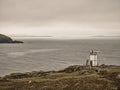 With the water of Swarbacks Minn in the background, the remote, automated, solar powered  lighthouse at Muckle Roe Royalty Free Stock Photo