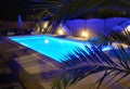 Water of swimming pool illuminated in blue