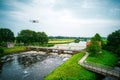 Water swirls from the weir in the river Vecht in the Netherlands. Downstream, Lock Keeper's House next to the bridge Royalty Free Stock Photo