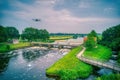 Water swirls from the weir in the river Vecht in the Netherlands. Downstream, Lock Keeper's House next to the bridge