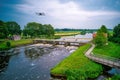 Water swirls from the weir in the river Vecht in the Netherlands. Downstream, Lock Keeper's House next to the bridge