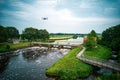 Water swirls from the weir in the river Vecht in the Netherlands. Downstream, Lock Keeper's House next to the bridge Royalty Free Stock Photo