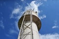 Water tank. Bottom-up view of a white painted water tank with a side ladder, with a blue sky with clouds in the background, Brazil Royalty Free Stock Photo