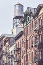 Water tank and fire escapes in downtown New York Royalty Free Stock Photo