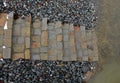 Water tank wall. slope is covered with coarse gravel against erosion of the reservoir by waves. service staircase made of stone bl Royalty Free Stock Photo