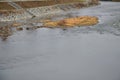 Water tank wall. slope is covered with coarse gravel against erosion of the reservoir by waves. service staircase made of stone bl Royalty Free Stock Photo