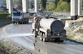 Water tanker splashes water on the road to prevent dust on work site. Royalty Free Stock Photo