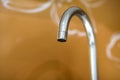 Water tap, chrome stainless metal faucet in bathroom or kitchen, mixer cold hot water isolated on bright yellow copy space Royalty Free Stock Photo