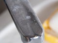 Water tap close-up in the bathroom with a white coating. Royalty Free Stock Photo