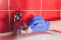 Water tap in detail with limescale close up soiled bathroom Calcified faucet. gloves for washing Sponge