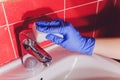 Water tap in detail with limescale close up soiled bathroom Calcified faucet. gloves for washing Sponge