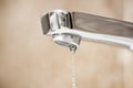 Water tap and drops of water. Water tap with dripping waterdrop. Water leaking, saving Royalty Free Stock Photo