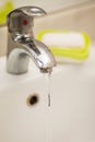 Water tap faucet with flowing water in a bathroom sink Royalty Free Stock Photo