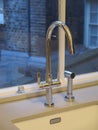 Water tap. Kitchen tap. Water kitchen tap near the window. Royalty Free Stock Photo