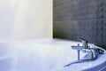 Water tap sink with faucet detail of jacuzzi with wall mount shower attachment Royalty Free Stock Photo