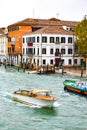 Water taxi and a boat transporting goods, sailing through the Grand Canal in Venice, Italy Royalty Free Stock Photo