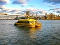 Water Taxi and Brooklyn bridge, seen from Pier 17, at Lower Manhattan in New York. South Street Seaport is a historic area of Man Royalty Free Stock Photo