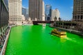 Water taxi carries party-goers across a dyed green Chicago River