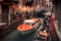 A water taxi passes under a small bridge on a narrow canal in Venice, Italy Royalty Free Stock Photo