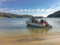 A water taxi picking up people from the beach at Watering Cove, Able Tasman National Park Royalty Free Stock Photo