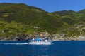 A water taxi sails past the Cinque Terre village of Vernazza, Italy