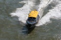 Water taxi speeding on the river in Rotterdam, Netherlands