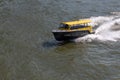 Water taxi speeding on the river in Rotterdam, Netherlands