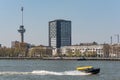 Water taxi speeding on the river in Rotterdam, Netherlands