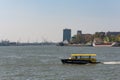 Water taxi speeding on the river in Rotterdam, Netherlands