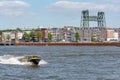 Water taxi speeding on the river in Rotterdam, Netherlands