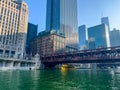 Water taxi under the Wells Street bridge on a dyed-green Chicago River to celebrate St. Patrick`s Day