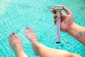 Water temperatur in a swimming pool with feets Royalty Free Stock Photo