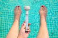 Water temperatur in a swimming pool with feets Royalty Free Stock Photo
