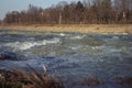 Water texture. Mountain river on the background of the city. Royalty Free Stock Photo