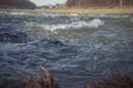 Water texture. Mountain river on the background of the city. Royalty Free Stock Photo