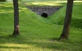 Water throughput pipe for a stream in park Royalty Free Stock Photo