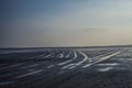 Water tide tracks on sandy beach at sunset