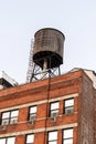 Water tower atop a red brick building Royalty Free Stock Photo