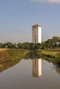 Characteristic historic water tower is reflected in the calm water. Royalty Free Stock Photo