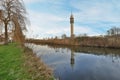 a river with a tall tower in the background Royalty Free Stock Photo