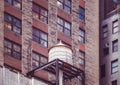 Water tower on a roof of an old building in Manhattan, color toning applied, New York City, USA Royalty Free Stock Photo