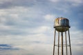 Water tower under cloudy skies