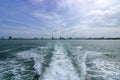 Water trail surface behind a ferry boat.