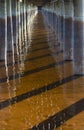 Water under bridge with refelection of sunlight