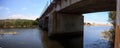 Water under the railroad track bridge leading down to the ocean Royalty Free Stock Photo