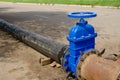 A water valve on a pipe that drains excess water. sewer cleaning