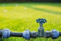 Water valve pipe in the green garden grass field Royalty Free Stock Photo